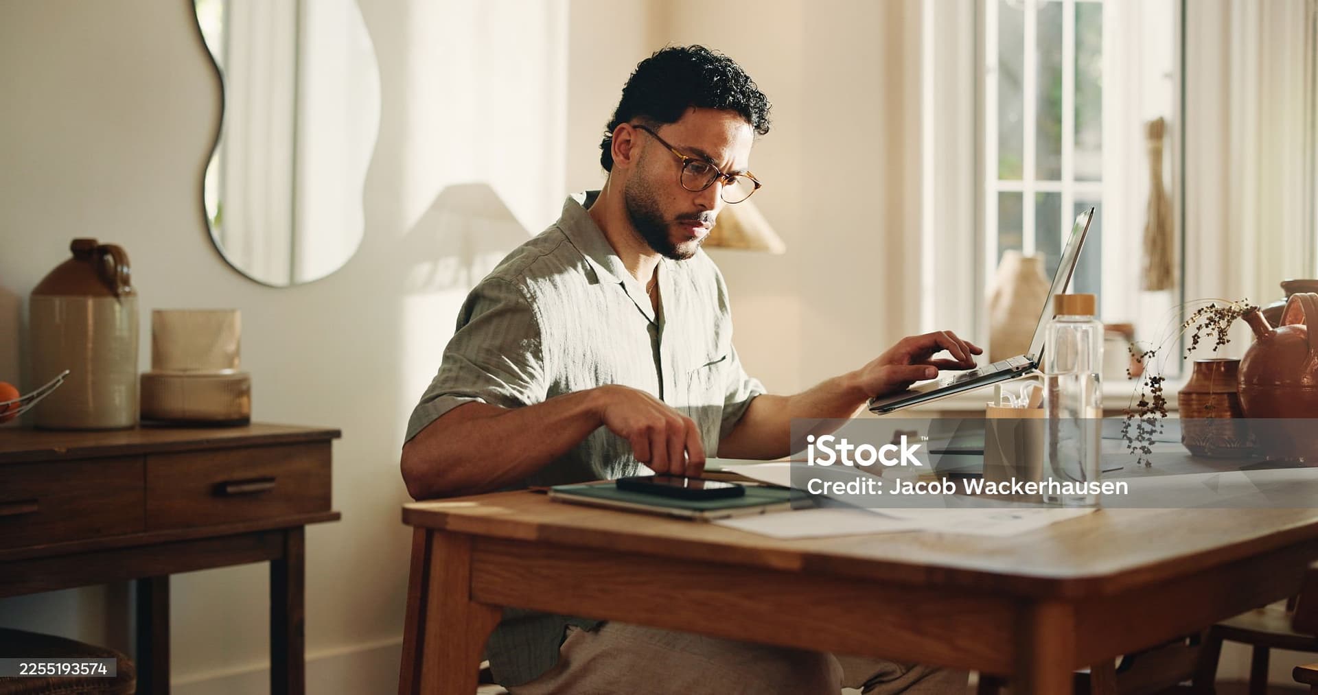 Entrepreneur working from home office with laptop and tablet